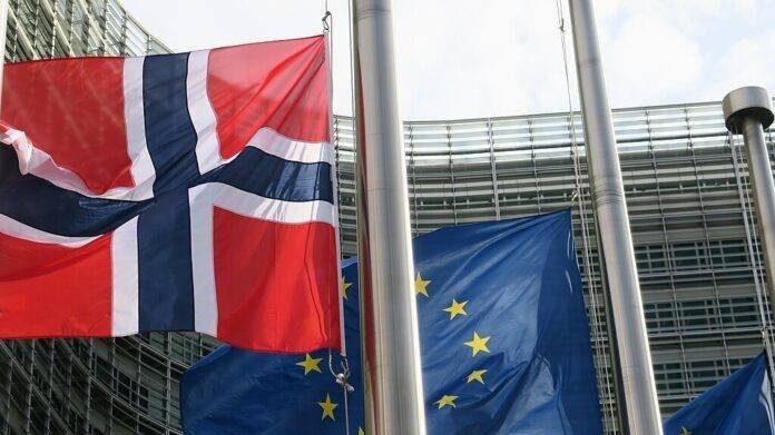 Bilde av EU-flagget og det norske flagget utenfor Europakommisjonsbygget i Brussel